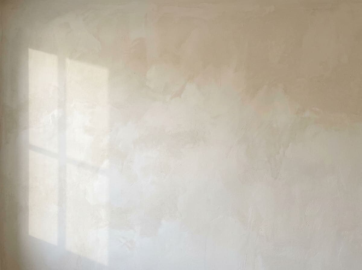Warm white lime wash texture in morning light
